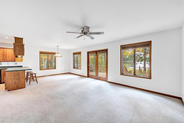 W8547 Cloverleaf Lake Rd, Clintonville, WI 54929 - unfurnished living room with baseboards, light carpet, and a ceiling fan