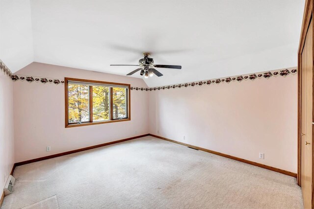 W8547 Cloverleaf Lake Rd, Clintonville, WI 54929 - spare room with vaulted ceiling, light colored carpet, ceiling fan, a baseboard radiator, and baseboards
