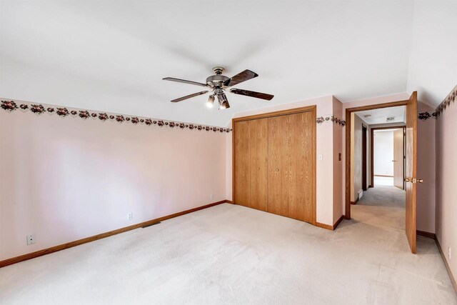 W8547 Cloverleaf Lake Rd, Clintonville, WI 54929 - unfurnished bedroom with light carpet, baseboards, a closet, and a ceiling fan