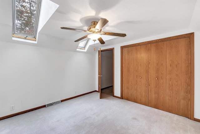 W8547 Cloverleaf Lake Rd, Clintonville, WI 54929 - unfurnished bedroom featuring a skylight, carpet, baseboards, and a ceiling fan
