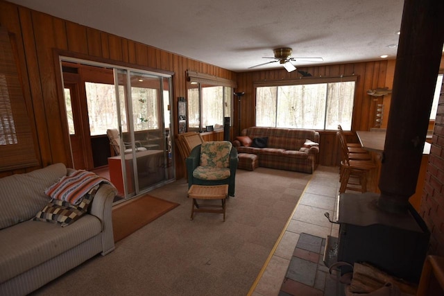 W1514 Spirit Ridge Trl, Keshena, WI 54135 - living room with plenty of natural light, ceiling fan, wooden walls, and light colored carpet