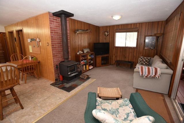 W1514 Spirit Ridge Trl, Keshena, WI 54135 - living area with a wood stove, wooden walls, and a textured ceiling