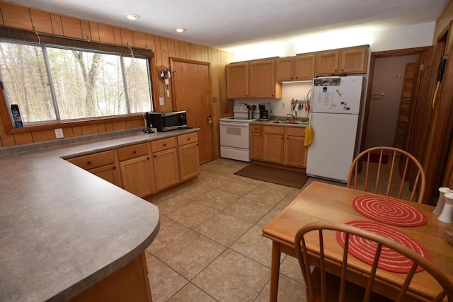 W1514 Spirit Ridge Trl, Keshena, WI 54135 - kitchen with white appliances, a sink, light tile patterned floors, recessed lighting, and wooden walls