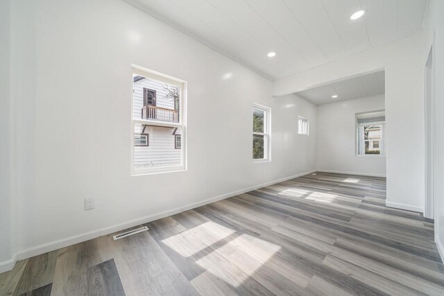 unfurnished room featuring recessed lighting, visible vents, baseboards, and wood finished floors