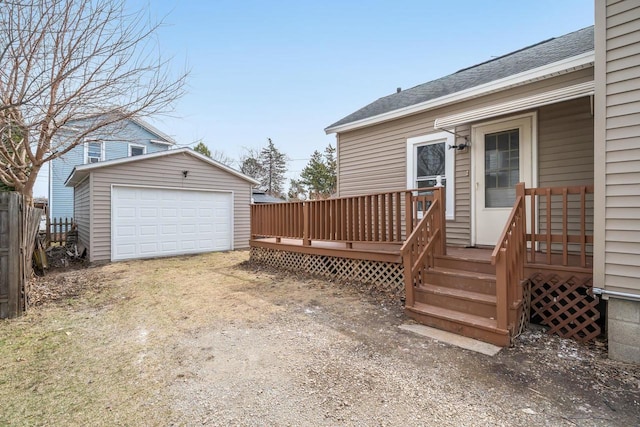view of yard featuring an outbuilding, driveway, a wooden deck, and a garage