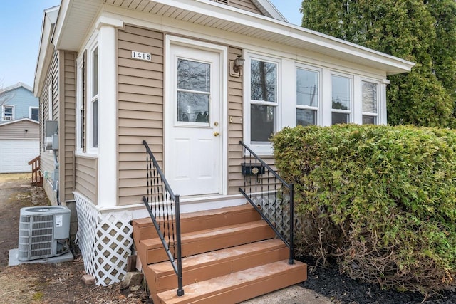 doorway to property featuring central AC unit