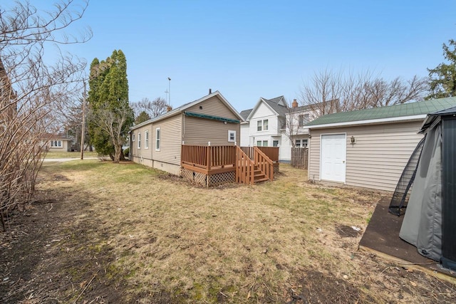 view of yard featuring a wooden deck and an outbuilding