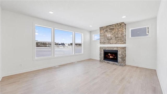 1517 Creekwood Dr, New Richmond, WI 54017 - unfurnished living room featuring a fireplace, light wood-style flooring, baseboards, and recessed lighting