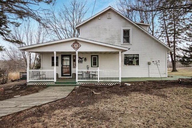 8283 345th St, Stanley, WI 54768 - view of front of house with a chimney and covered porch