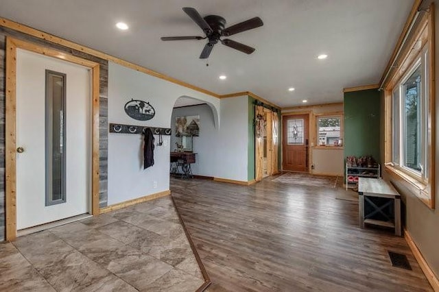 8283 345th St, Stanley, WI 54768 - entrance foyer with arched walkways, a ceiling fan, visible vents, wood finished floors, and baseboards