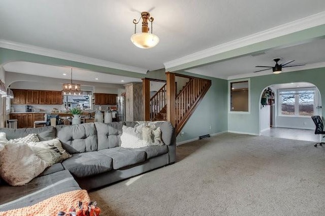 8283 345th St, Stanley, WI 54768 - living room with baseboards, arched walkways, carpet, crown molding, and stairway