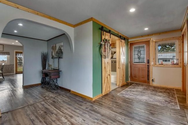 8283 345th St, Stanley, WI 54768 - foyer with arched walkways, wood finished floors, ornamental molding, and a barn door