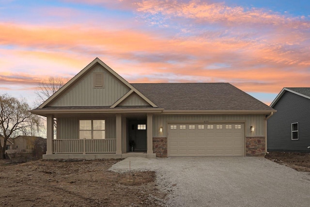 6101 Fox Run Ln, Mount Pleasant, WI 53406 - view of front of home with an attached garage, stone siding, driveway, and roof with shingles