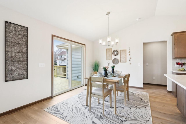 6101 Fox Run Ln, Mount Pleasant, WI 53406 - dining room with baseboards, light wood-type flooring, a chandelier, and lofted ceiling