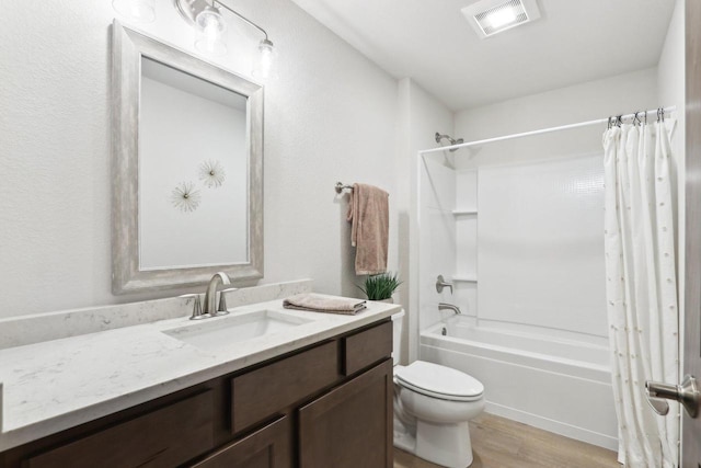 6101 Fox Run Ln, Mount Pleasant, WI 53406 - bathroom featuring visible vents, toilet, shower / bath combo with shower curtain, vanity, and wood finished floors