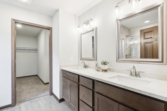 6101 Fox Run Ln, Mount Pleasant, WI 53406 - full bathroom with a sink, a spacious closet, a shower stall, and double vanity