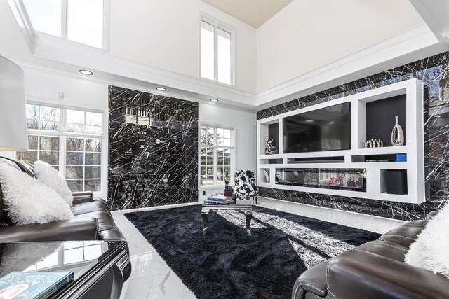 N4455 Dorothy Jane Ct, Kaukauna, WI 54130 - living area with stone wall, an accent wall, marble finish floor, and a high ceiling