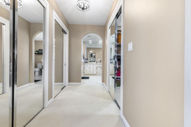 N4455 Dorothy Jane Ct, Kaukauna, WI 54130 - corridor featuring baseboards, arched walkways, and light carpet