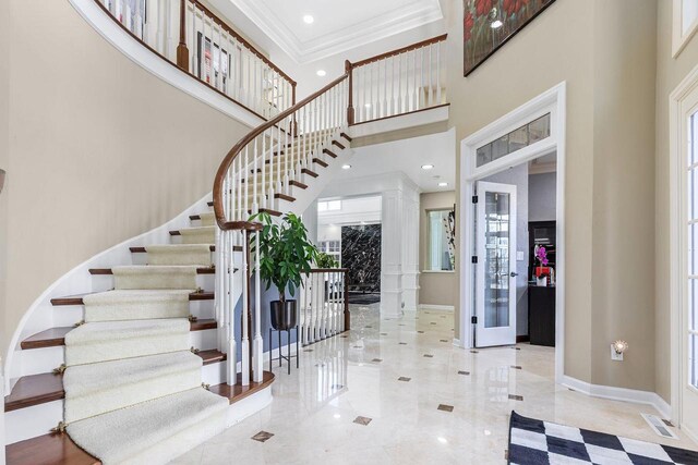 N4455 Dorothy Jane Ct, Kaukauna, WI 54130 - entrance foyer with a towering ceiling, ornamental molding, visible vents, stairs, and baseboards