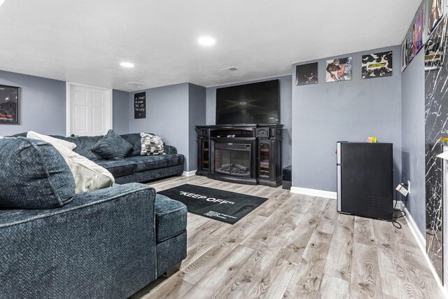 N4455 Dorothy Jane Ct, Kaukauna, WI 54130 - living area with visible vents, baseboards, a glass covered fireplace, and wood finished floors