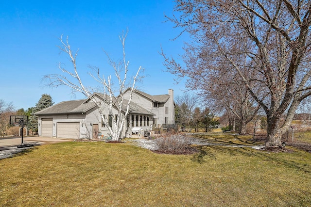 9842 Elan Rd, Tomah, WI 54660 - view of side of property with a chimney, a lawn, and driveway