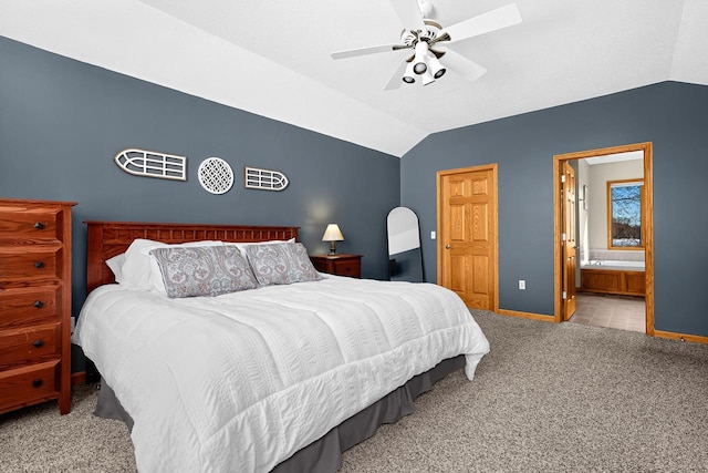 9842 Elan Rd, Tomah, WI 54660 - carpeted bedroom featuring vaulted ceiling, baseboards, connected bathroom, and ceiling fan