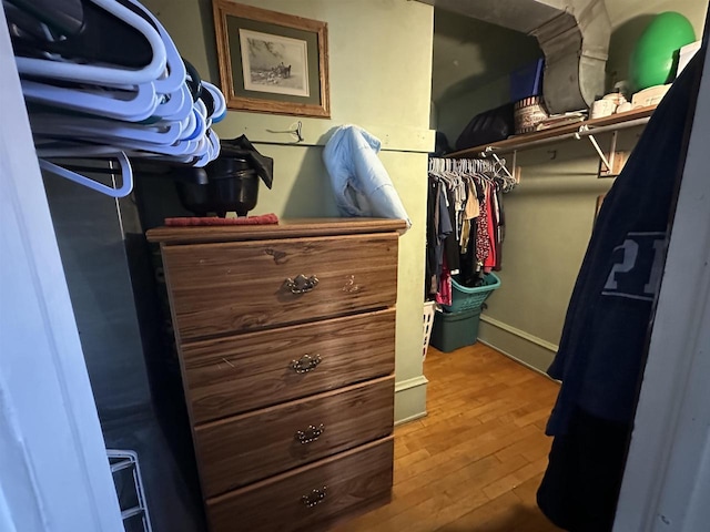 walk in closet featuring wood finished floors