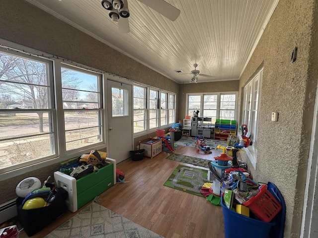 sunroom / solarium with ornamental molding, a textured wall, wood finished floors, and wood ceiling