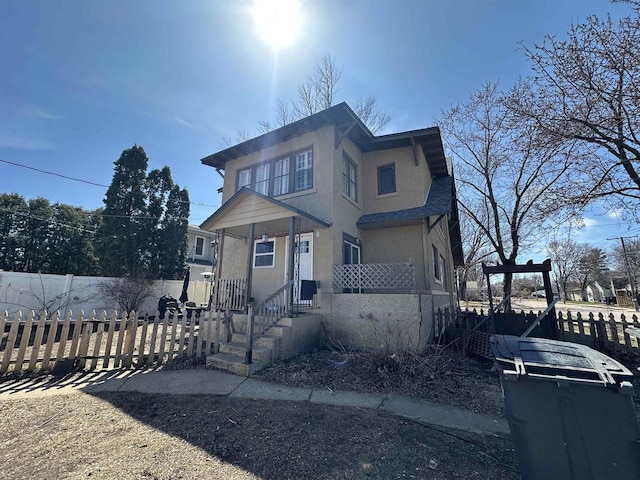 view of front of home with a fenced front yard and stucco siding