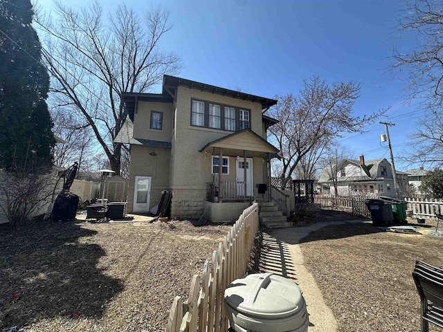 view of front of property with a fenced front yard and stucco siding