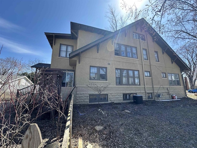 view of property exterior featuring central AC unit and stucco siding