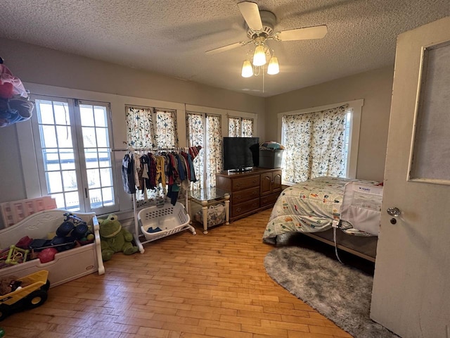 bedroom with a textured ceiling and a ceiling fan