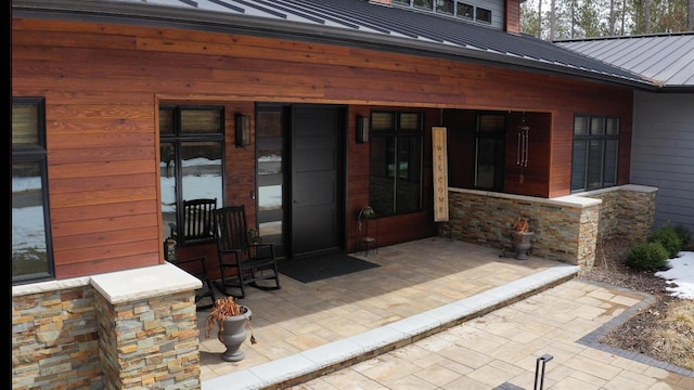 entrance to property with a standing seam roof and metal roof