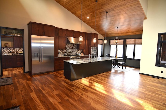 kitchen featuring visible vents, dark wood finished floors, under cabinet range hood, stainless steel appliances, and high vaulted ceiling