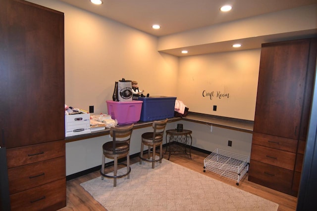 office featuring wood finished floors, baseboards, and recessed lighting