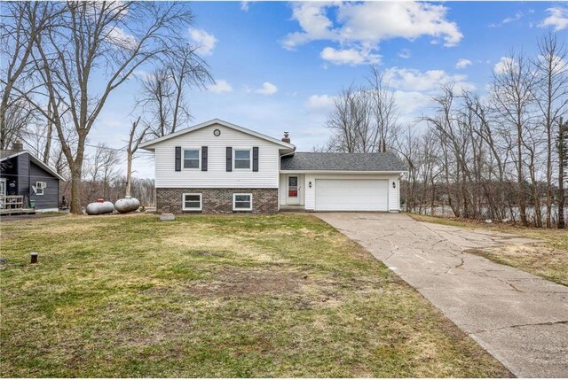 1794 W White Ash Dr, Balsam Lake, WI 54810 - tri-level home with an attached garage, driveway, a front yard, and brick siding