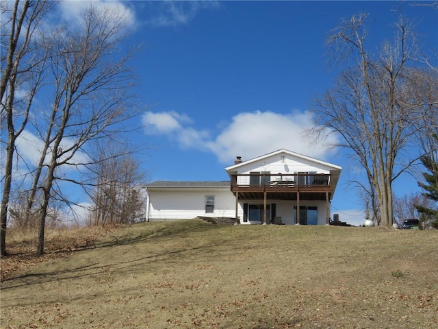 1794 W White Ash Dr, Balsam Lake, WI 54810 - view of front of home featuring a deck, a chimney, and a front yard