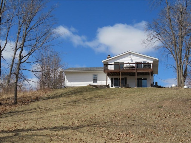 1794 W White Ash Dr, Balsam Lake, WI 54810 - view of front facade with a wooden deck, a front yard, and a chimney