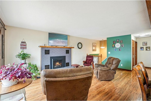 1794 W White Ash Dr, Balsam Lake, WI 54810 - living room featuring light wood-style floors, a fireplace, and a textured ceiling
