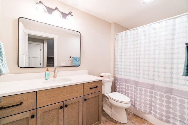 bathroom featuring toilet, vanity, and a shower with curtain