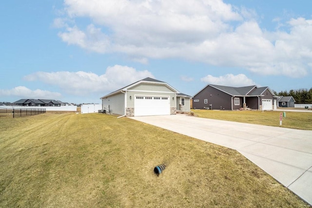 single story home featuring fence, stone siding, a front lawn, an attached garage, and driveway