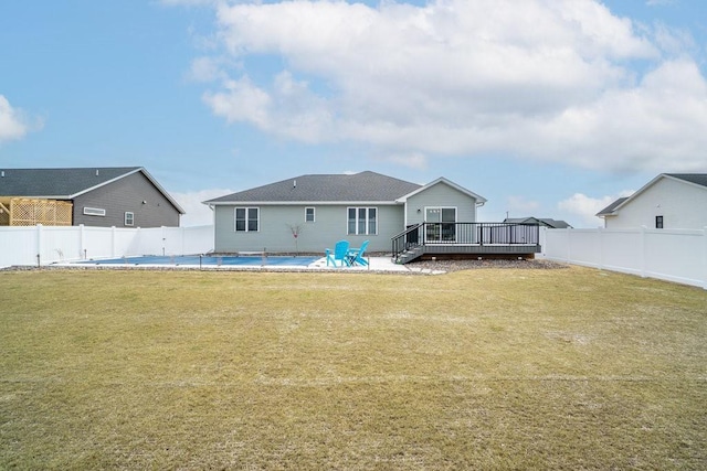 back of property featuring a fenced in pool, a yard, a deck, and a fenced backyard