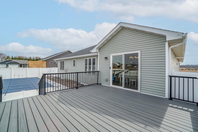 wooden terrace featuring a patio area and fence