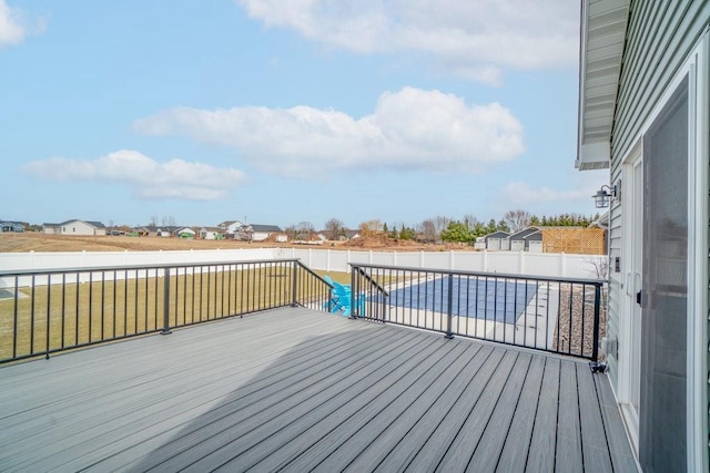 wooden deck featuring a yard and a fenced backyard