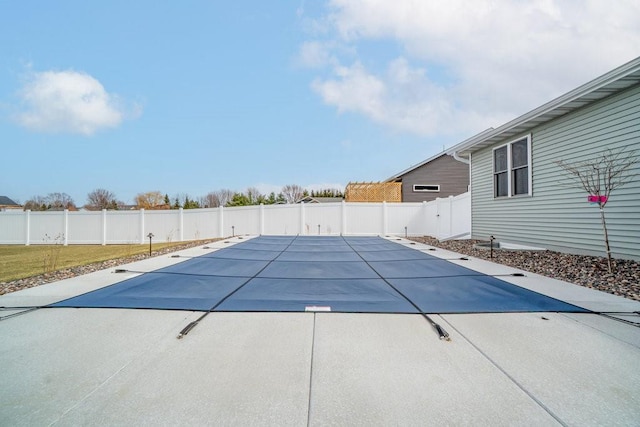 view of swimming pool with a patio and a fenced backyard
