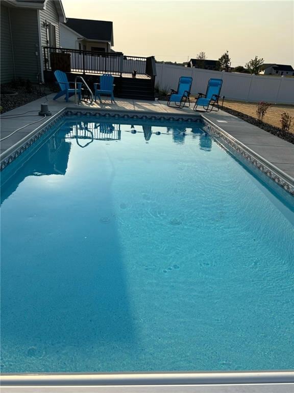 view of swimming pool with a patio area, a fenced in pool, and fence