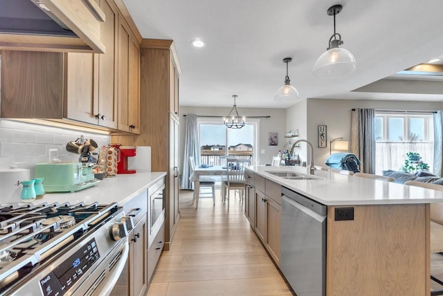 kitchen featuring a sink, light countertops, light wood-style flooring, and stainless steel appliances
