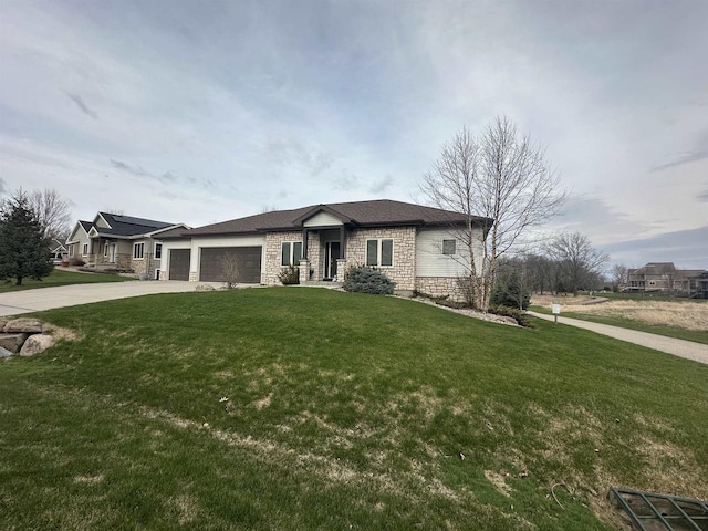 prairie-style home with concrete driveway, an attached garage, stone siding, and a front lawn