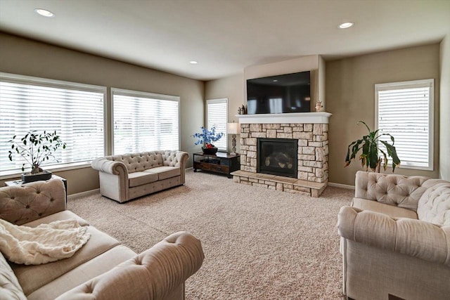 carpeted living area with recessed lighting, baseboards, and a fireplace