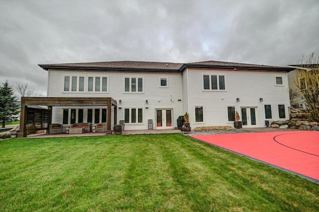 back of property with a yard, french doors, and a patio